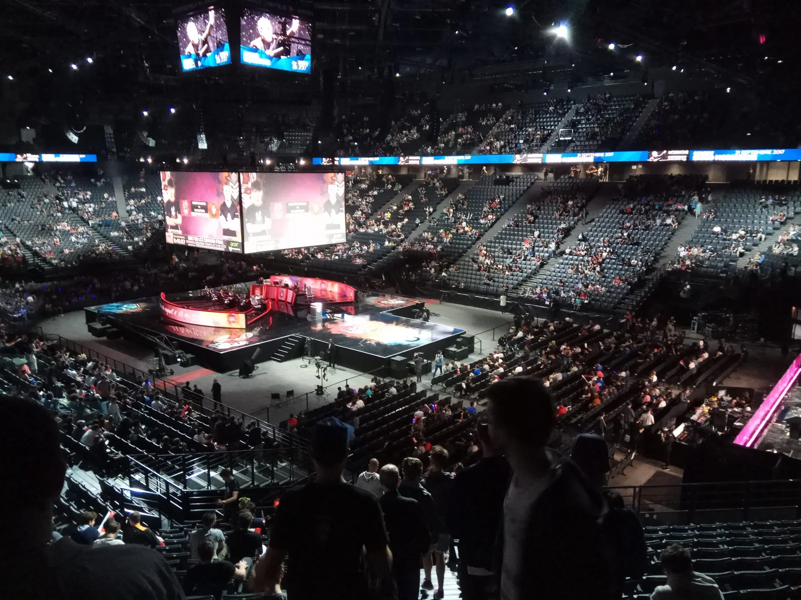 Large esports tournament arena with stage and spectators