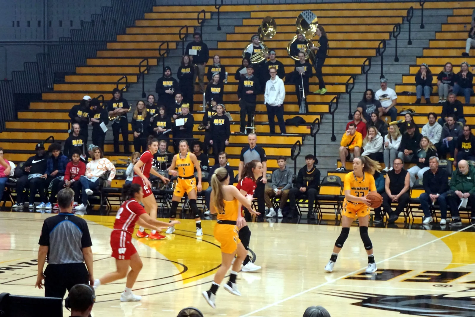 Women competing during an indoor basketball game
